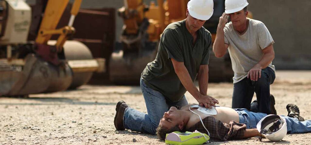 Workers doing CPR on another coworker